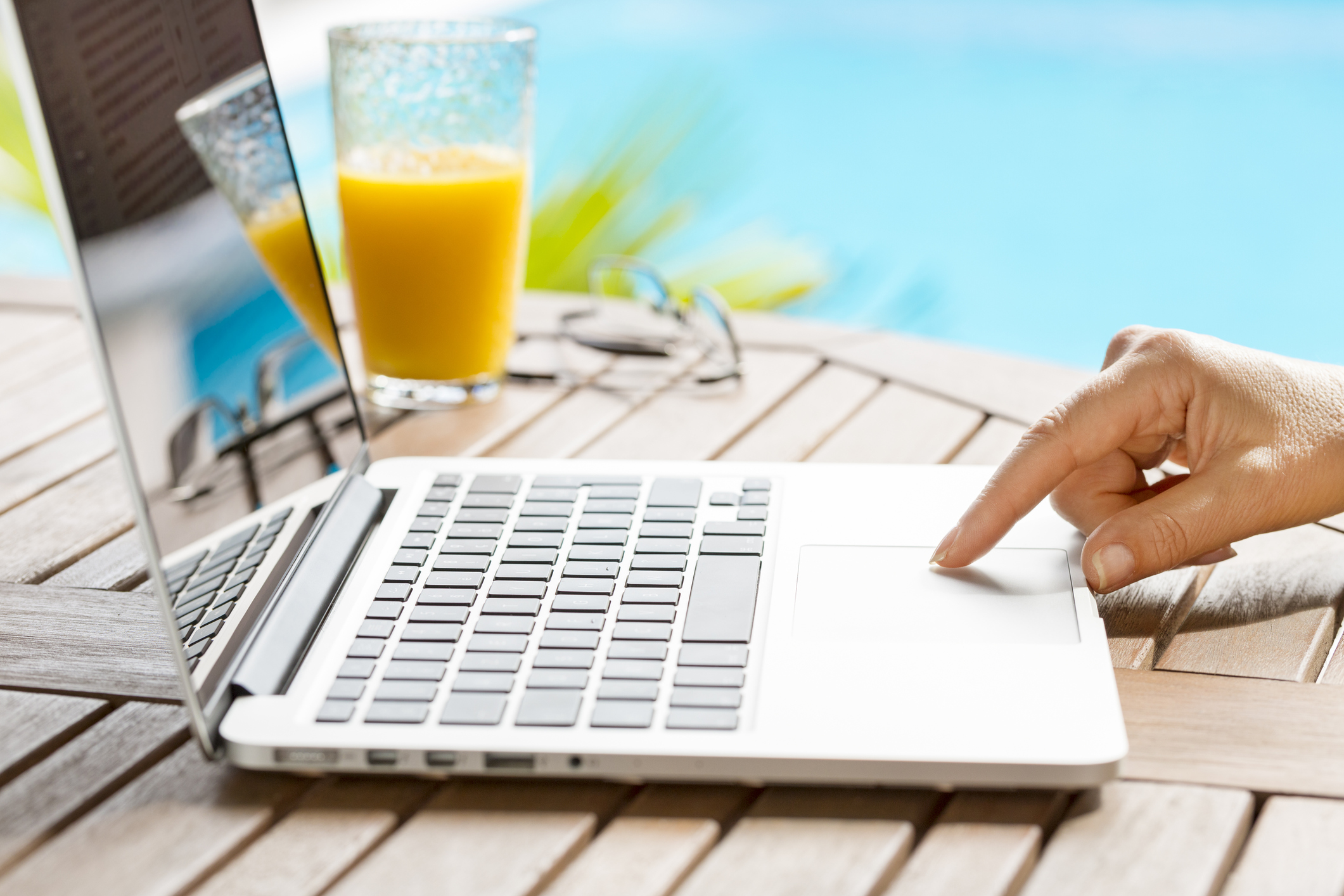 In garden a woman surfing on internet with laptop.